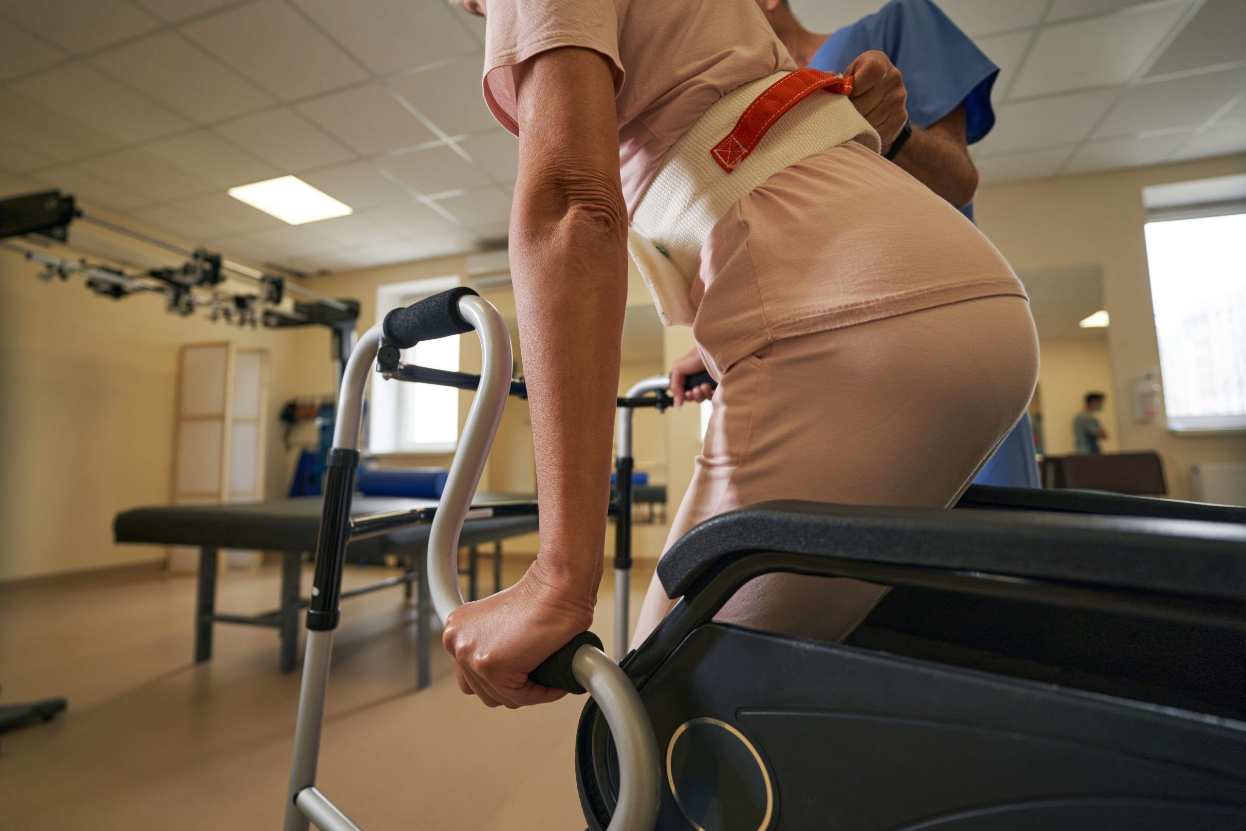a woman at a physical therapist office, prompting the difference between physical therapy and rehabilitation